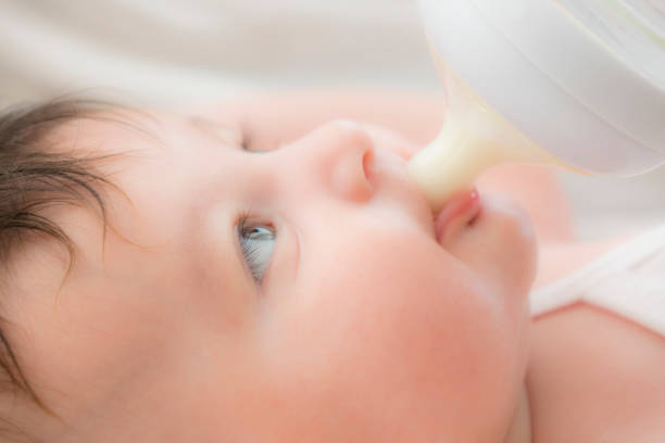 istock newborn baby sucking bottle 1043007826