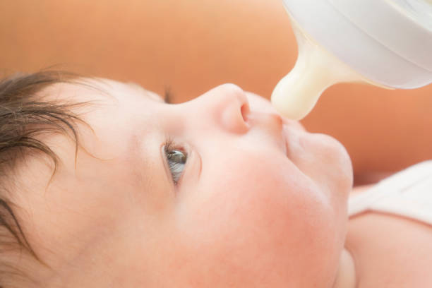 istock newborn baby sucking bottle 1043008462