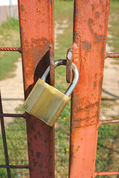istock Closed metal door with a padlock 1043011506