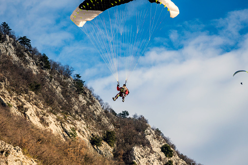 Senior man with gray long beard paragliding in Julian Alps, Primorska Region in Slovenia, Europe,Nikon D850