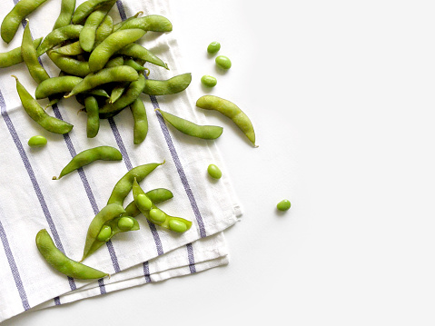 Edamame soy beans on a white background, top view