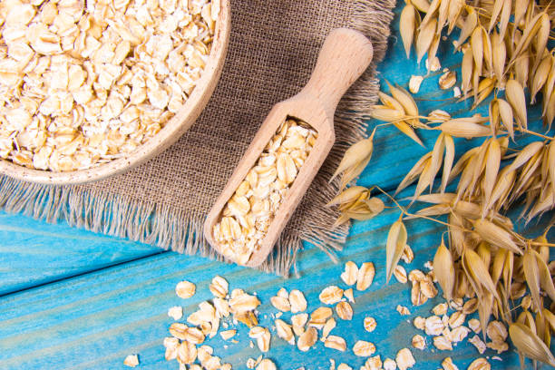 istock Oat flakes in a bowl on the blue board. 1043017242