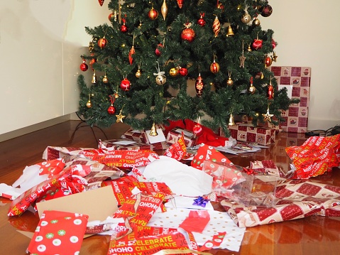 Beautiful wrapped Christmas presents under the tree - holiday season concepts