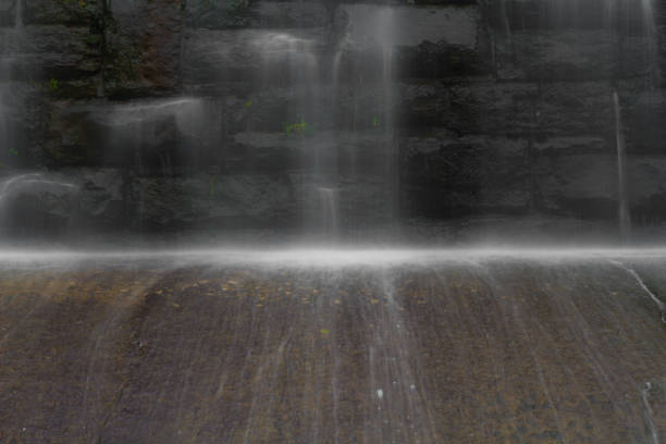 istock Water Flowing Over Dam At Deteriorating Reservoir 1043026444