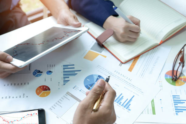 istock Businessteam are analyzing graphs.They use a tablet and have secretary take notes. 1043031596