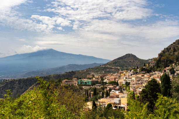 istock Etna volcano with clouds surrounding the mountain top 1043031890