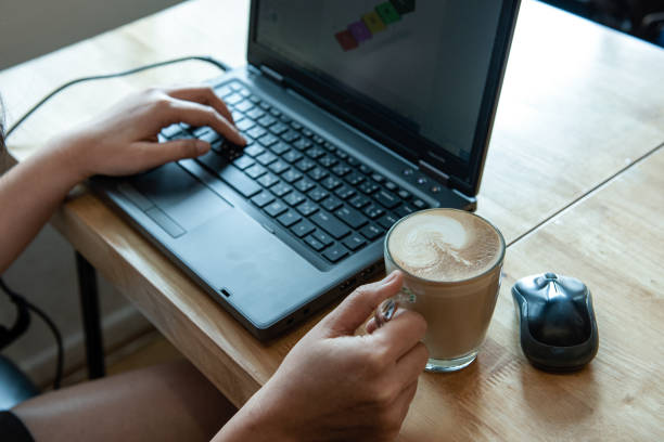istock Woman hand holding latte coffee,She is working. 1043032320