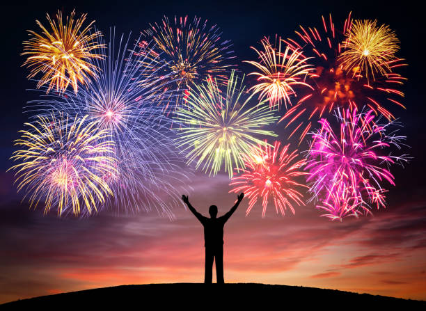 istock Happy man on celebration background with colorful firework. 1043032936