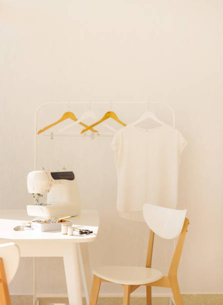 istock Workplace for sewing and needlework in a bright room with white furniture. 1043035512
