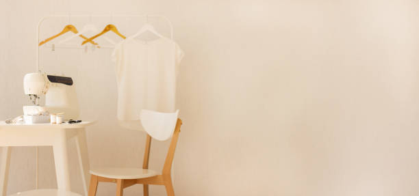 istock Workplace for sewing and needlework in a bright room with white furniture. 1043035524