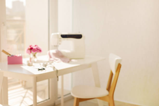 istock Workplace for sewing and needlework in a bright room with white furniture. 1043035532