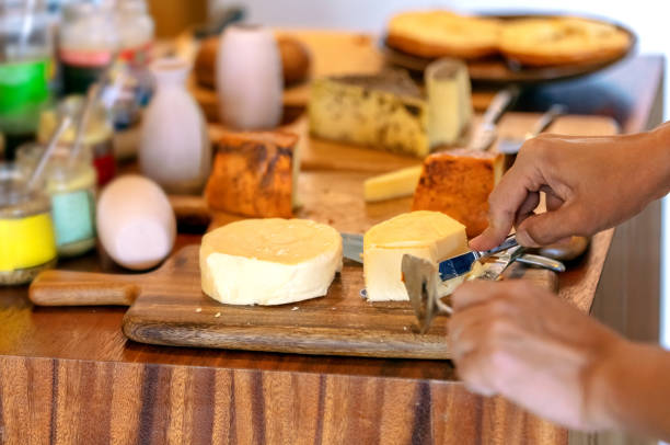 istock Cutting cheese on wooden board 1043040810