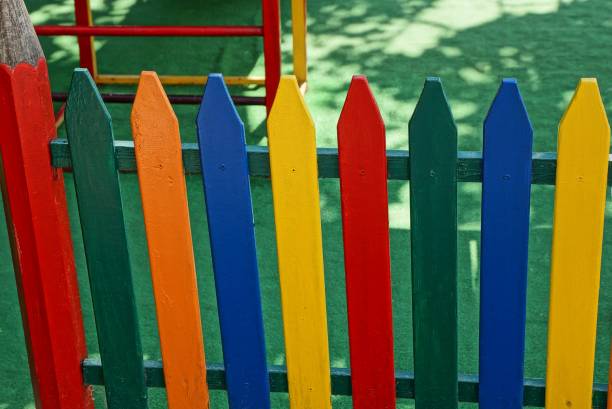 istock colored decorative fence from boards at a children playground 1043054298