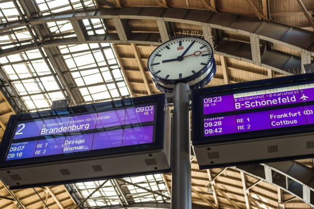 station clock in alexanderplatz at berlin, germany - clock station people berlin germany imagens e fotografias de stock