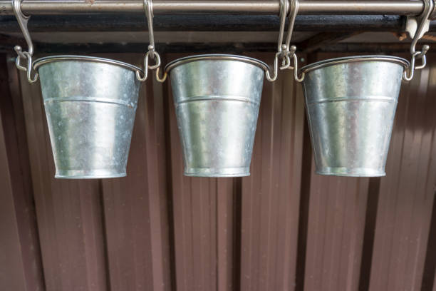 istock Three stainless tree pot hanging from metal rail. 1043059154