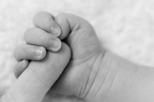 istock A baby holding their parent's finger 1043059570