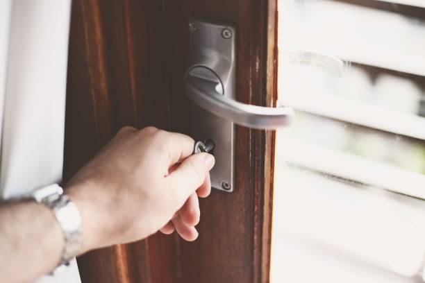 istock A man unlocking a door with a key. This image can be used to represent home security. 1043062118