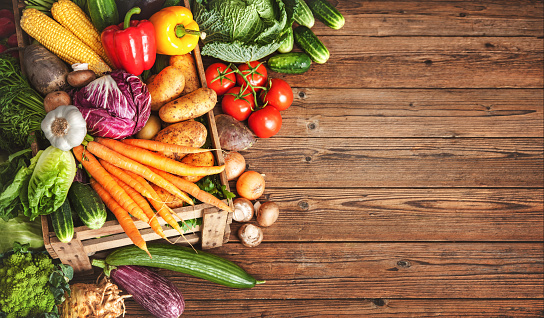 Assortment of fresh vegetables on wooden background