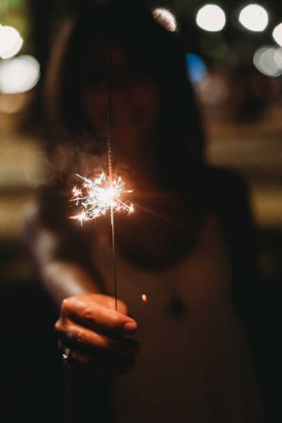 istock Holding a sparkler to celebrate 1043062502