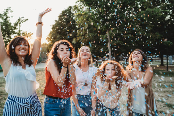 istock Friends having fun together with confetti at a party 1043062550