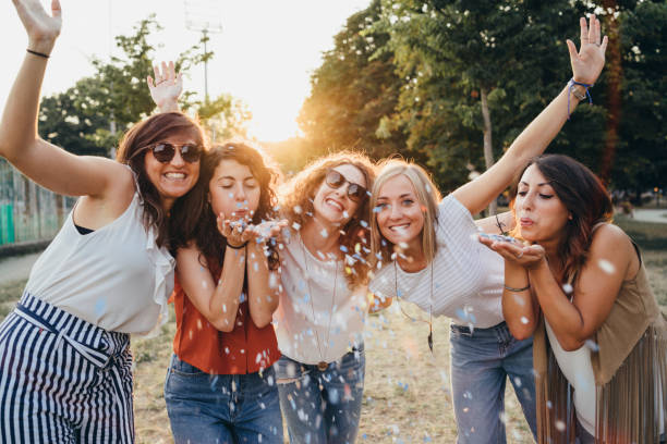 istock Friends having fun together with confetti at a party 1043062554