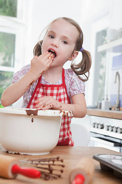 istock Germany, Munich, Girl (4-5) tasting batter, portrait 104306498