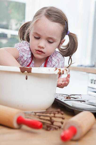 istock Germany, Munich, Girl (4-5) baking cookies 104306499