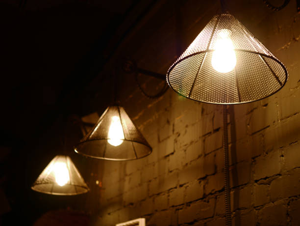 istock Vintage lighting lamp hang in front of cement brick wall at loft 1043065242