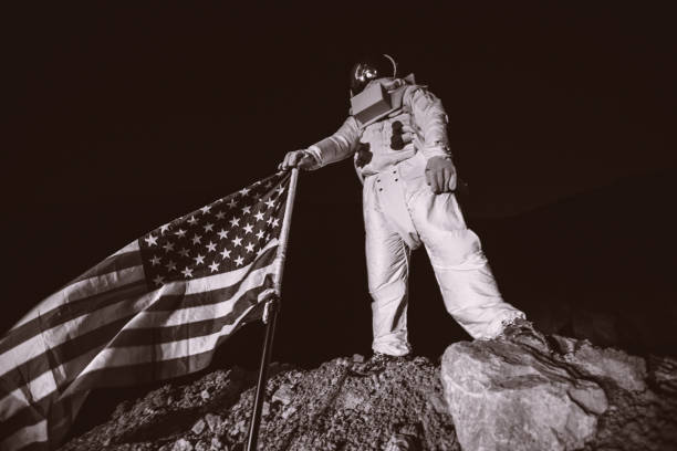 Proud American Astronaut Holding American Flag Proud American Astronaut Plant American Flag on the Alien Plane cosmonaut photos stock pictures, royalty-free photos & images