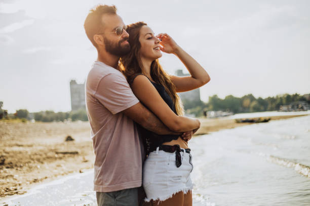 istock Lovers in the warm embrace at the beach 1043070416