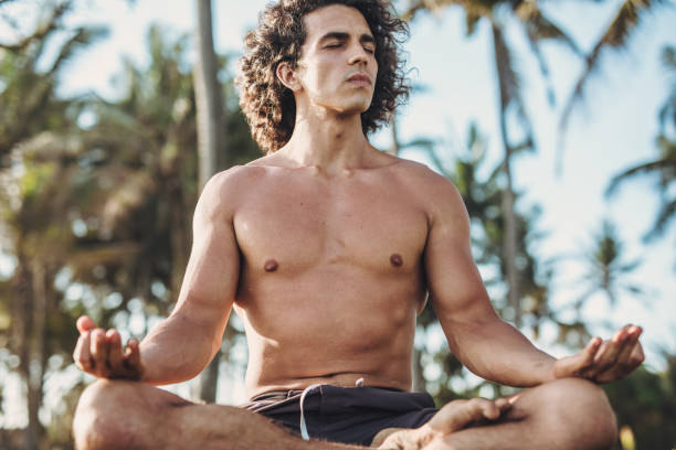 istock Shirtless man doing meditation exercises 1043078378