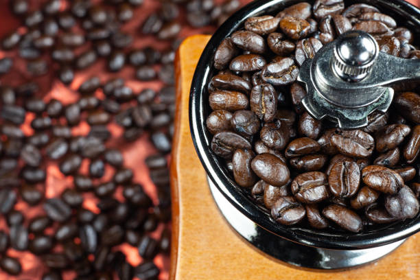 istock Coffee beans and vintage wooden grinder. 1043081792