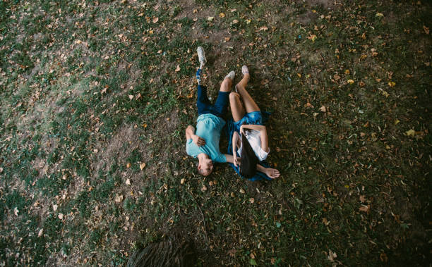 istock Happy couple lying on the grass 1043082216