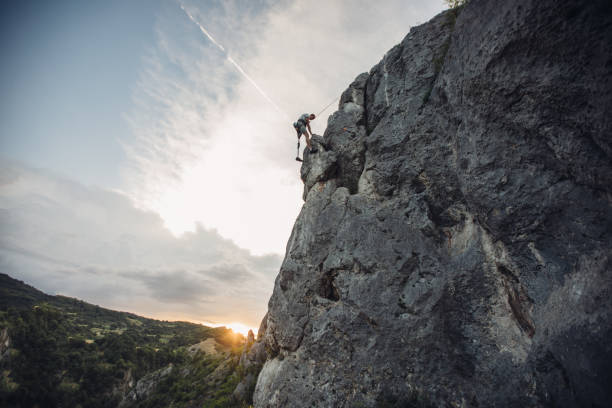 istock Young man with prosthetic leg free rock climbing 1043086286