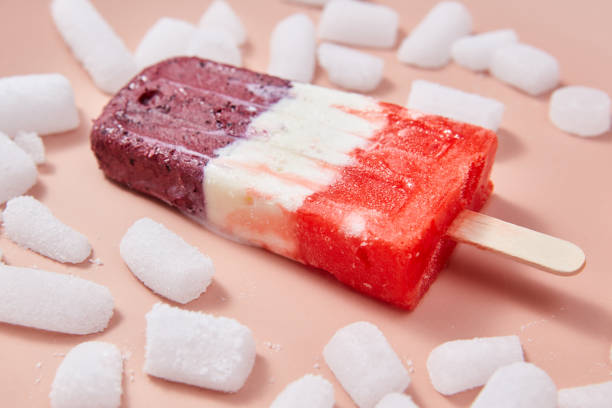 istock Fruit berry appetizing ice lolly with ice slices on a pink background. 1043088754