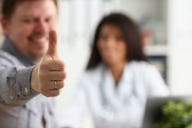 istock Man showing ok sign with thumb up at physician 1043089348