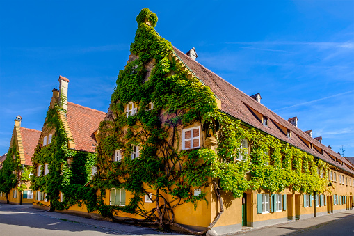 The Fuggerei is a housing complex in the Augsburg downtown, founded in 1516 as a place to host needy citizens. Augsburg is located on the famous Romantic Road (Romantische Straße), a \