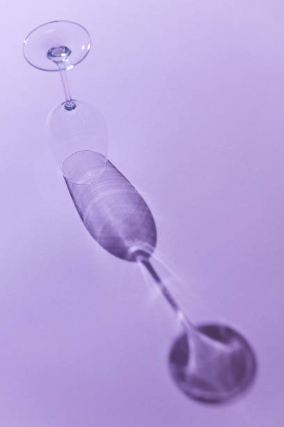 istock Clear empty wine glass on purple background 1043090010