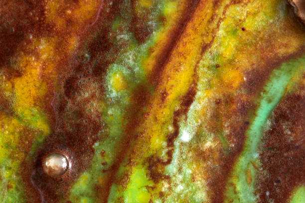 istock Close up background from multi colored melting ice crem - yellow, green, brown. Summer concept. 1043090028