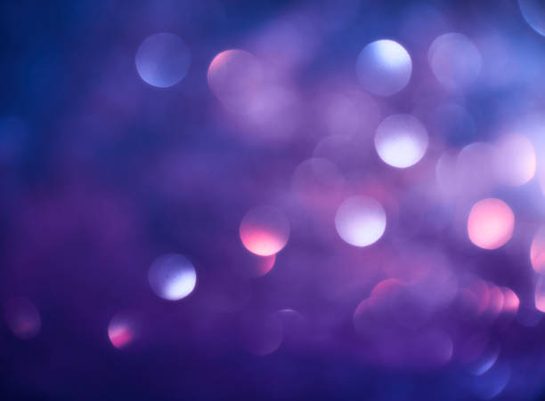 istock Blurred background lights. Abstract defocused gold, white, red and yellow glitters texture on black background. Shining glowing snow effects 1043093140