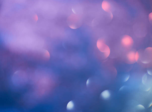 istock Blurred background lights. Abstract defocused gold, white, red and yellow glitters texture on black background. Shining glowing snow effects 1043093170