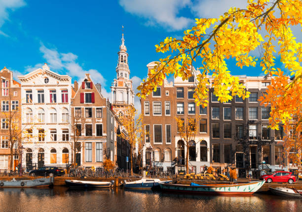 Houses of Amstardam, Netherlands Facades of old historic Houses over canal water, Amsterdam, Netherlands at fall canal house photos stock pictures, royalty-free photos & images