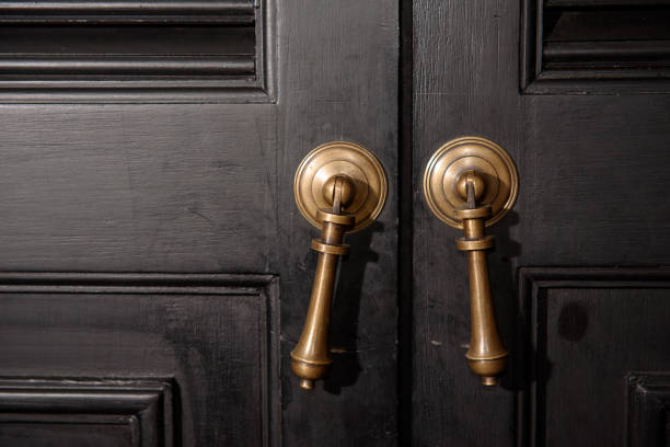istock Bronze door handle and wooden door 1043100540