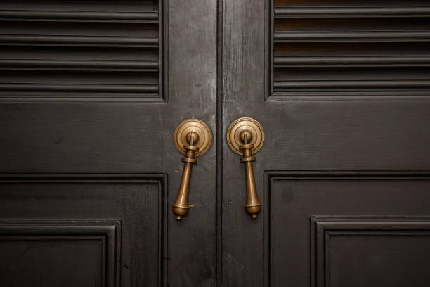 istock Bronze door handle and wooden door 1043100550