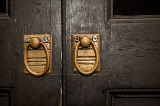 istock Bronze door handle and wooden door 1043100786