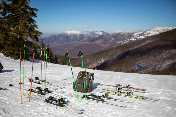 istock Skis and ski poles put in rack at slope 1043104892