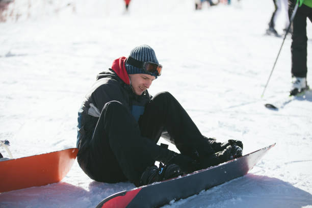 istock Young man snowboarding on the snowy mountain 1043104992