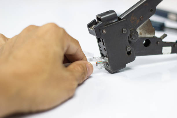 istock Technician to install an RJ45 connector on a CAT5 Ethernet network 1043107392
