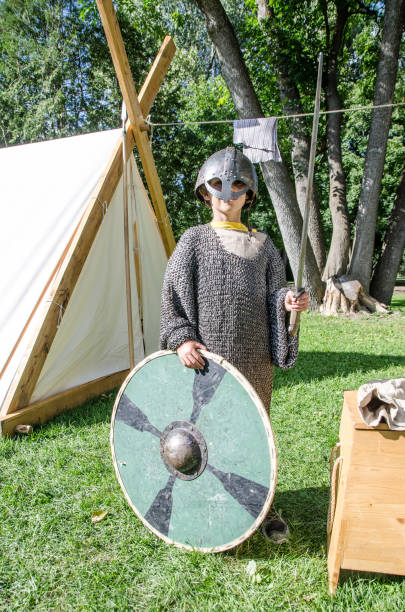 istock Boy dressed as a Celtic warrior and holding shield and sword in the air during summer day at Celtic Festival of Quebec city 1043110030