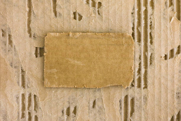 istock Piece of cardboard on tattered corrugated cardboard background. 1043111216